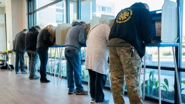 Six people cast their ballots in Wilmington voting booths