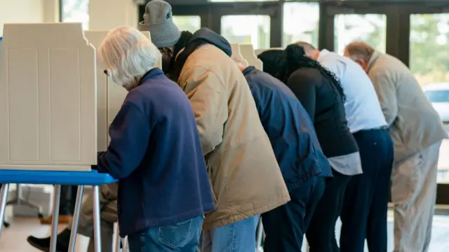 Six people cast their ballots in Wilmington voting booths