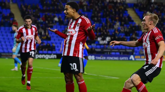 Exeter's Kamari Doyle celebrates opening the scoring at Shrewsbury