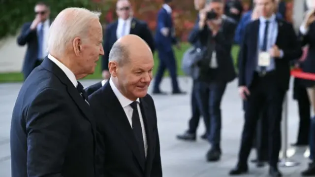 US President Joe Biden (L) is welcomed by German Chancellor Olaf Scholz for talks at the Chancellery in Berlin, on October 18, 2024