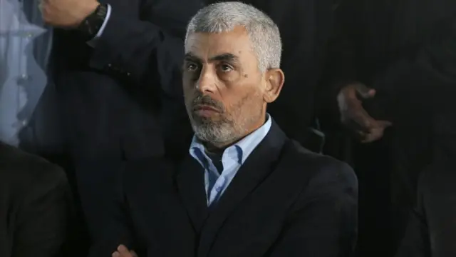 Yahya Sinwar wearing a suit and a blue shirt