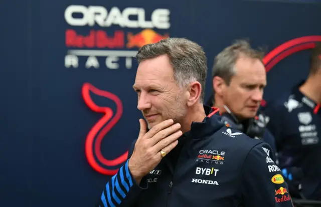 Christian Horner walks past the Red Bull motorhome