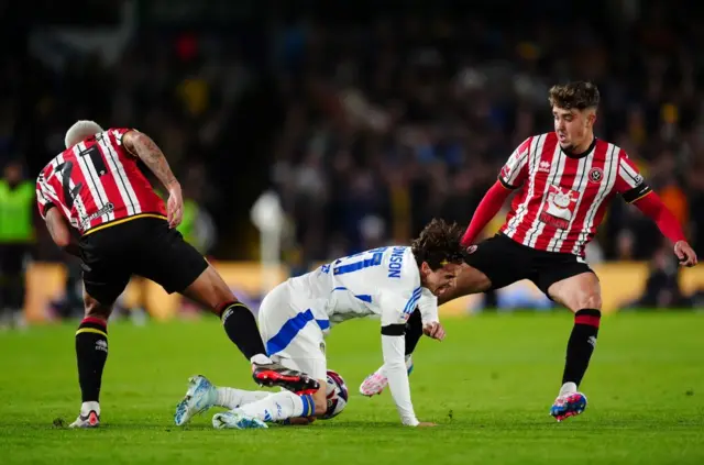 Leeds United's Brenden Aaronson (centre) battles with Sheffield United's Vinicius Souza (left) and Oliver Arblaster