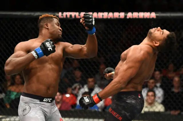 Francis Ngannou lands an uppercut on Alistair Overeem who is falling backwards