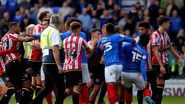 Sheffield United and Portsmouth players engaging in a post-match melee