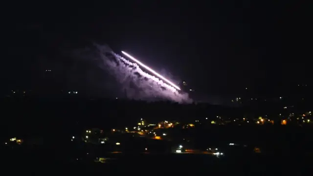 White streaks in the dark sky as trails of missiles were launched from Lebanon towards Israel as seen from the Galilee in northern Israel.