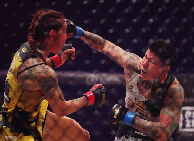 Cris Cyborg is punched by Larissa Pacheco