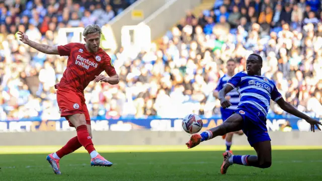 Reading defender Amadou Mbengue stretches to block Will Swan's effort for Crawley