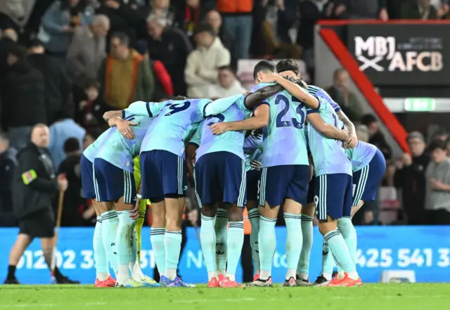 Arsenal players huddle before the second half