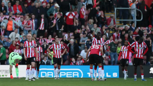 Southampton players look dejected after Jordan Ayew scores