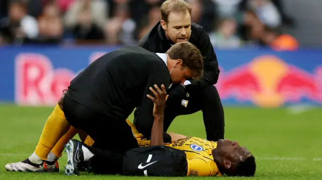 Danny Welbeck receives medical attention after sustaining an injury