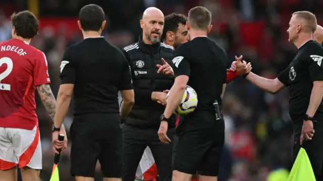 Erik ten Hag speaks to referee Samuel Barrott after the Premier League football match between Manchester United and Brentford