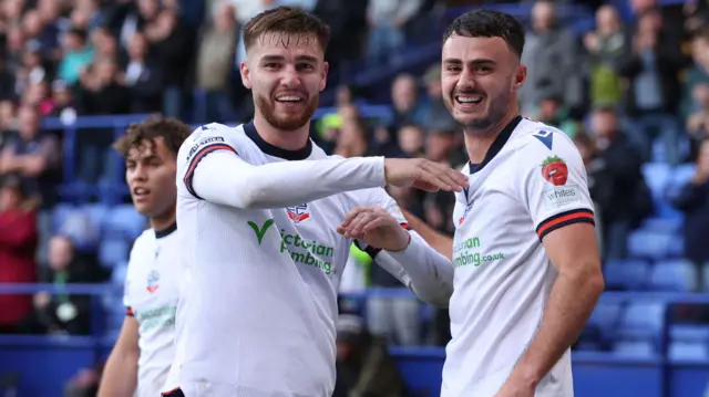 Bolton goalscorer Aaron Collins smiles for the cameras