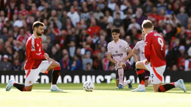 Brentford's Christian Norgaard takes a knee before the match