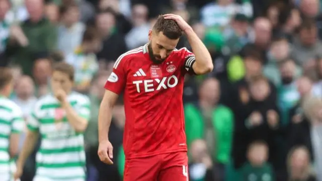 GLASGOW, SCOTLAND - OCTOBER 19: Aberdeen's Graeme Shinnie looks dejected during a William Hill Premiership match between Celtic and Aberdeen at Celtic Park, on October 19, 2024, in Glasgow, Scotland. (Photo by Ross MacDonald / SNS Group)