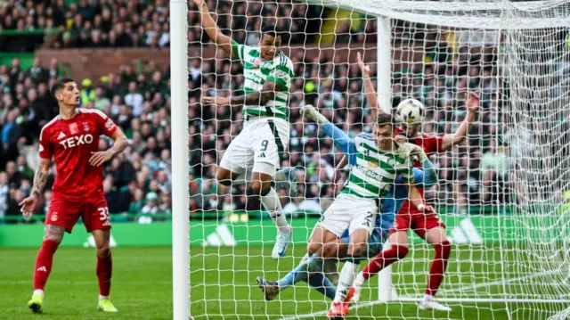 GLASGOW, SCOTLAND - OCTOBER 19: Celtic's Adam Idah heads the ball into the net but the goal is disallowed for a foul on Aberdeen goalkeeper Dimitar Mitov by Celtic's Alistair Johnston during a William Hill Premiership match between Celtic and Aberdeen at Celtic Park, on October 19, 2024, in Glasgow, Scotland. (Photo by Rob Casey / SNS Group)