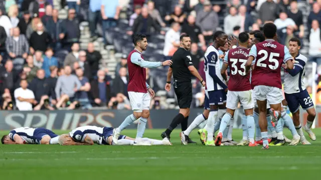 Tottenham Hotspur's Micky van de Ven and Richarlison are down as players clash