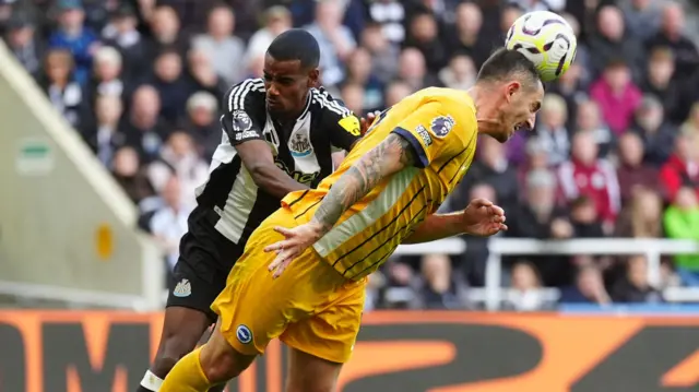 Newcastle's Alexander Isak and Brighton's Lewis Dunk battle for the ball