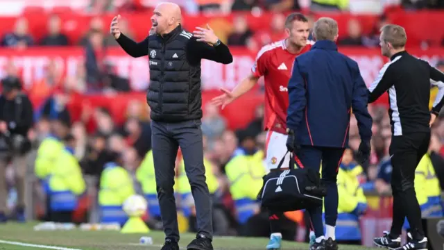 Erik ten Hag reacts following Brentford's first goal scored by Ethan Pinnock as his player, Matthijs de Ligt receives treatment on the sideline