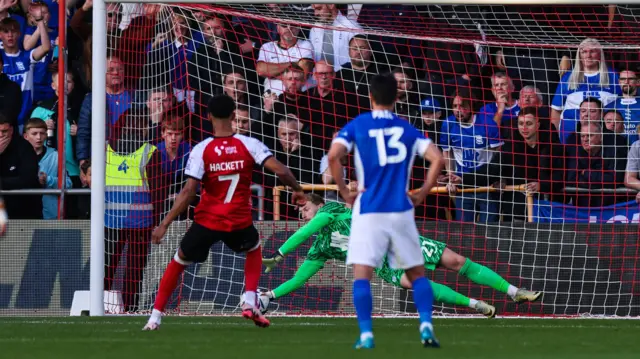 Ryan Allsop dives to save Reeco Hackett's penalty