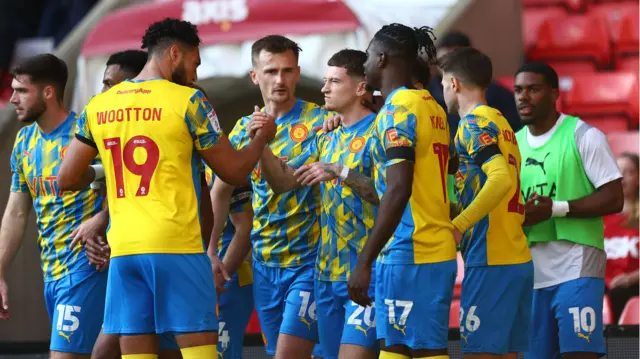 Stockport players celebrate Louie Barry's goal at Charlton