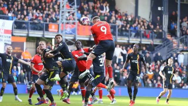 Carlton Morris scores a header