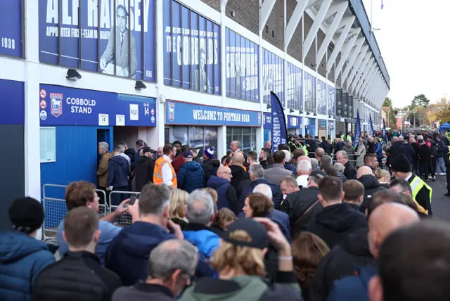 General view as fans are seen queuing to enter the stadium