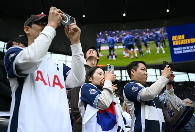 Fans of Tottenham Hotspur are seen taking photographs