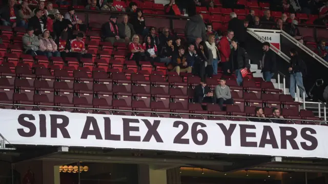 A banner supporting former Manchester United manager Sir Alex Ferguson after the termination of his ambassadorial contract with the club is seen in the stands