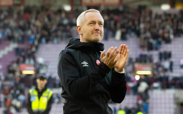 Neil Critchley applauds the fans at Tannadice