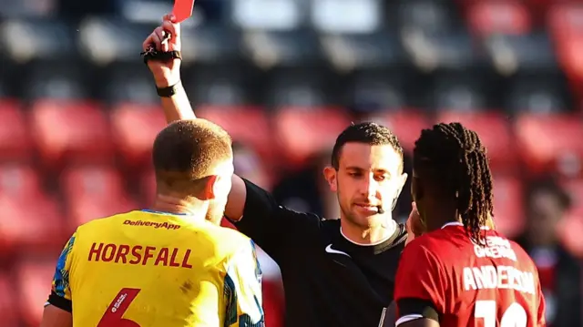 Stockport's Fraser Horsfall is shown a red card