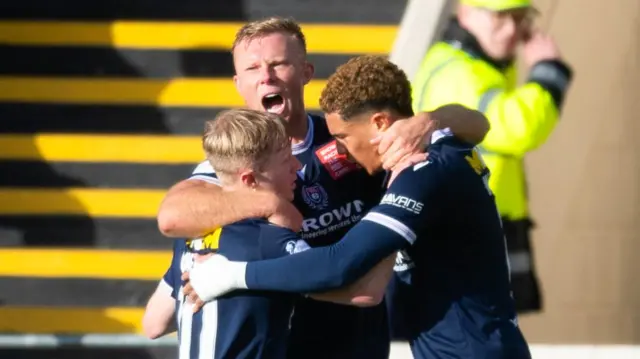 Dundee's Lyall Cameron (L) celebrates scoring to make it 1-0 with teammates Curtis Main (C) and Ethan Ingram (R) during a William Hill Premiership match between Motherwell and Dundee at Fir Park, on October 19, 2024, in Motherwell, Scotland.