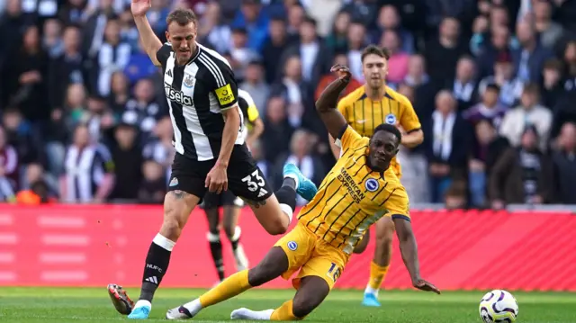 Newcastle United's Dan Burn and Brighton and Hove Albion's Danny Welbeck battle for the ball