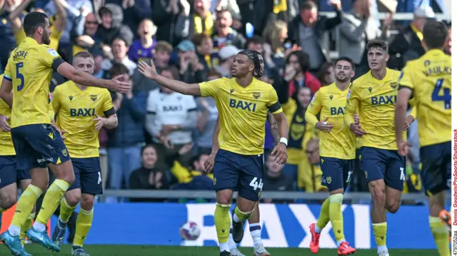 Dane Scarlett is congratulated by his team mates after equalising for Oxford