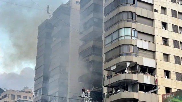 Smoke billows out of an apartment building in Beirut after an apparent Israeli air strike