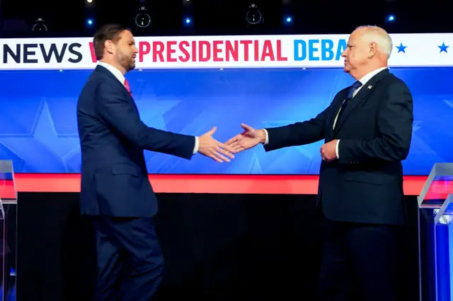 Senator JD Vance, a Republican from Ohio and Republican vice-presidential nominee, left, and Tim Walz, governor of Minnesota and Democratic vice-presidential nominee, shake hands while arriving for the first vice presidential debate at the CBS Broadcast Center in New York on 1 October 2024