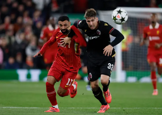 Miranda and Salah battle for the ball