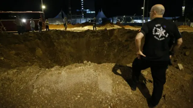 A large crater from a missile strike in a suburb of Tel Aviv