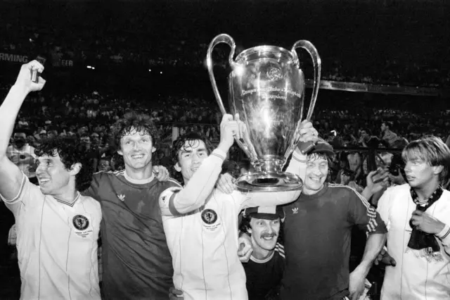 Villa captain lifts the trophy among his teammates