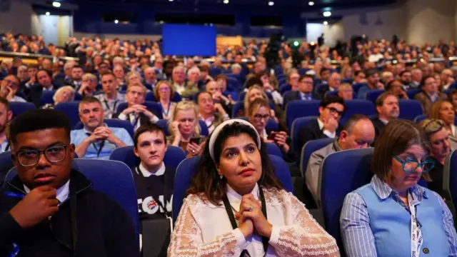 Delegates listen as they attend the Britain's Conservative Party's annual conference, in Birmingham, Britain, September 30