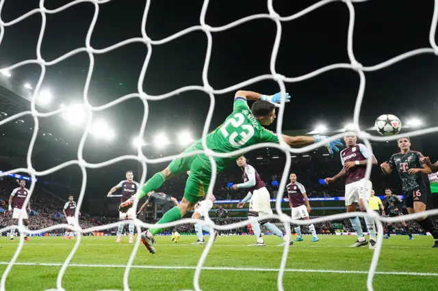 Martinez parries the shot behind the net