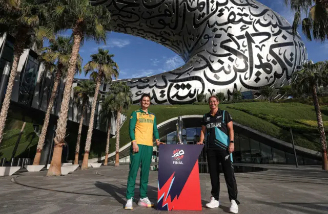 Laura Wolvaardt and Sophie Devine pose with the Women's T20 World Cup trophy