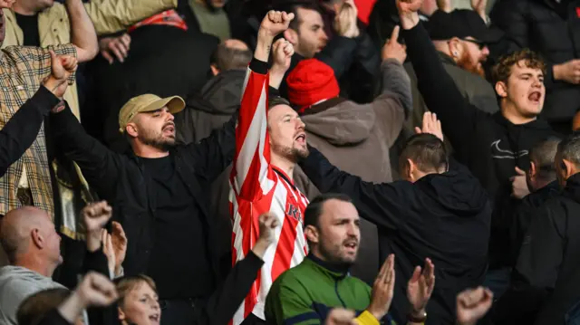 Sunderland fans celebrate winning at Hull City and going top of the Championship