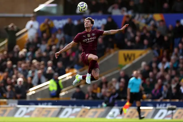 John Stones of Manchester City jumps up