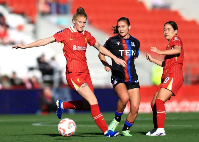 ndiah-Paige Riley of Crystal Palace passes the ball under pressure from Jasmine Matthews and Fuka Nagano