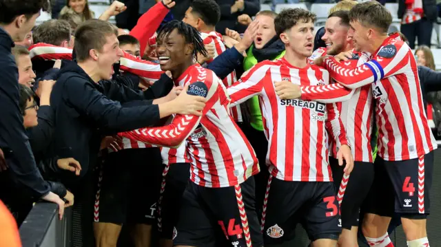 Sunderland players celebrate their last-minute equaliser against Leeds