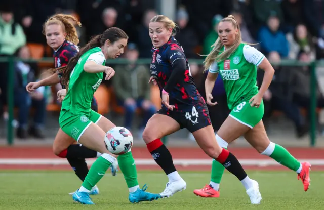 Katie Wilkinson (centre) flicks the ball past Shannon Leishman