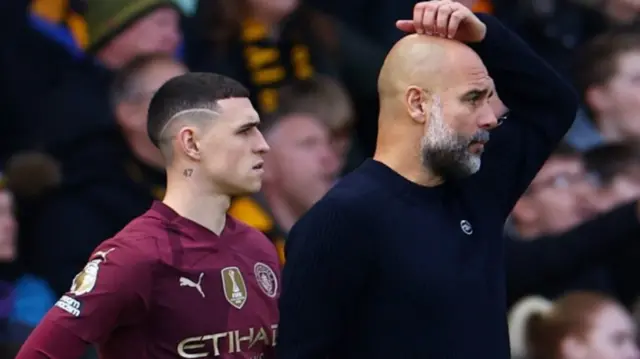 Manchester City manager Pep Guardiola reacts as Phil Foden waits to be substituted