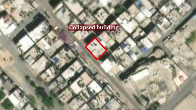 An aerial view of a city highlighting the location of a collapsed building with a red rectangle