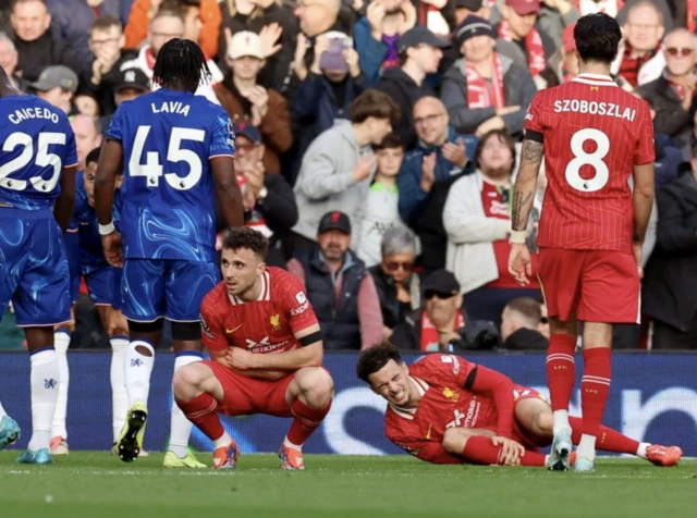 Liverpool's Curtis Jones reacts after being fouled